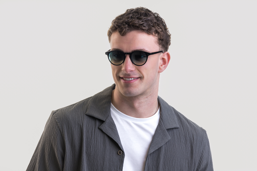 male model showcasing Bell. Sunglasses in Black with Lagoon Haze Gradient