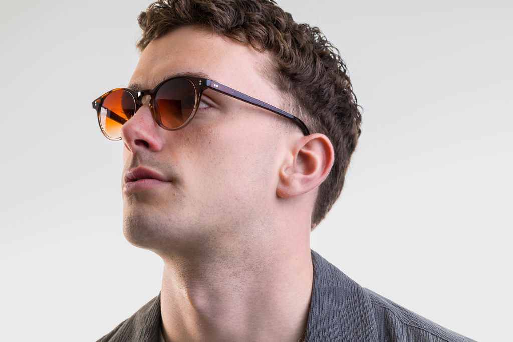male model wearing Bell sunglasses in Cola Fade with Sienna Sunset Gradient