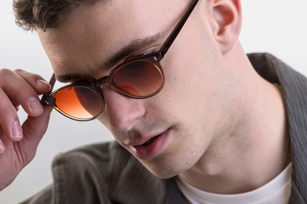 male model wearing Bell sunglasses in Cola Fade with Sienna Sunset Gradient
