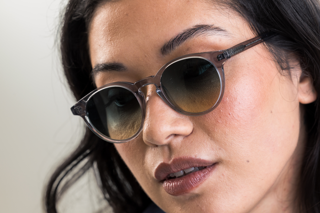 female model wearing Bell sunglasses in Light Grey Crystal with Lagoon Haze Gradient