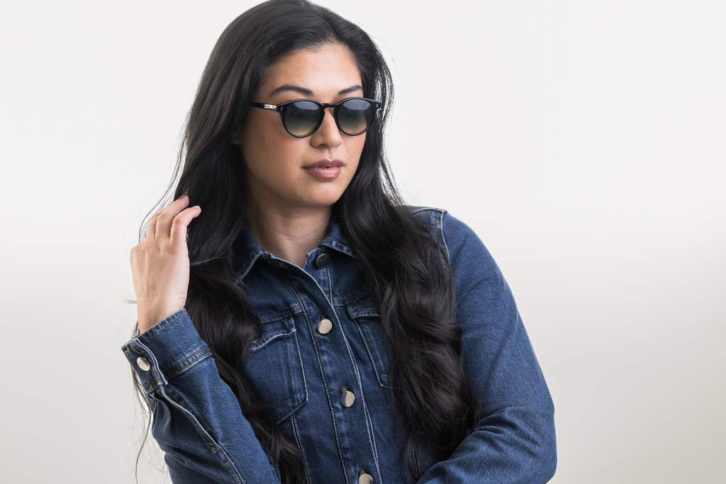 female model showcasing Bell. Sunglasses in Black with Lagoon Haze Gradient