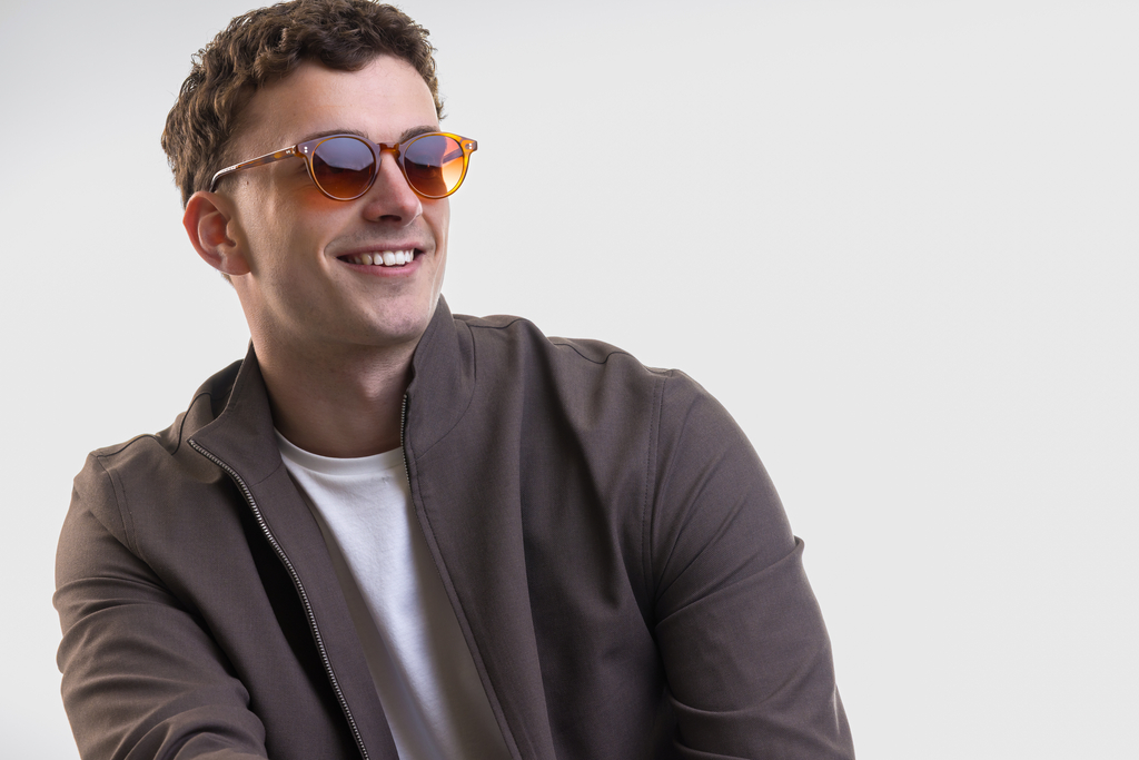 male model wearing Bell Sunglasses in Amber with Sienna Sunset Gradient