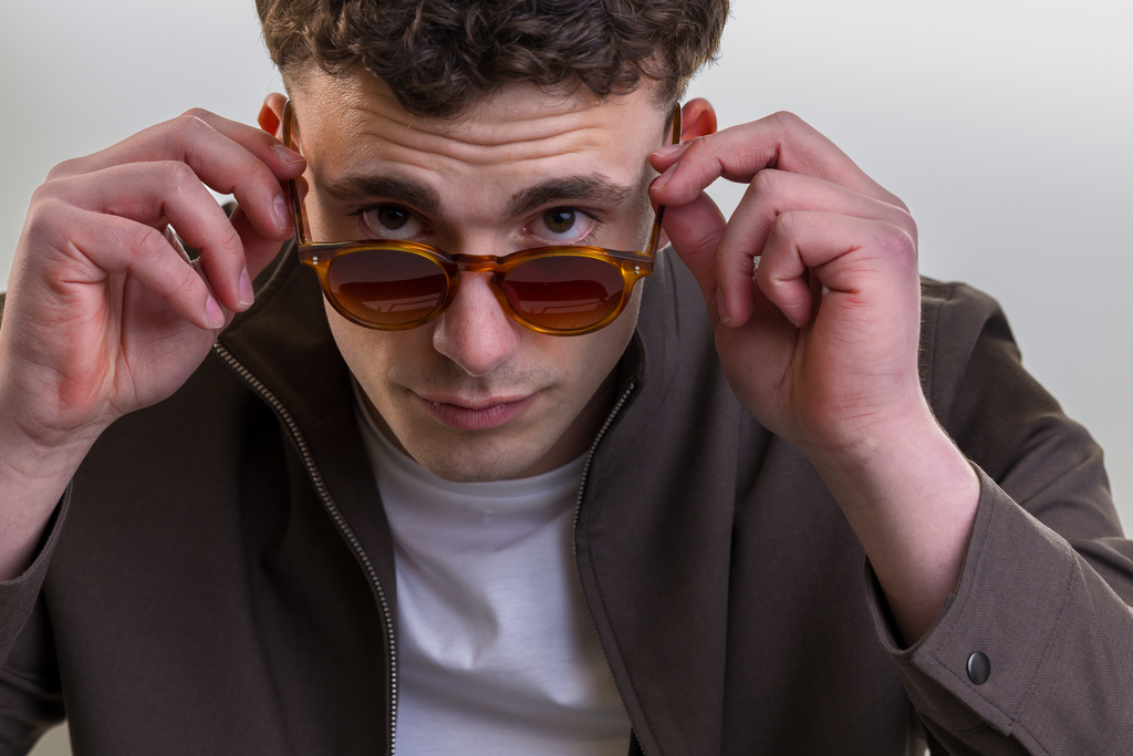 male model wearing Bell Sunglasses in Amber with Sienna Sunset Gradient
