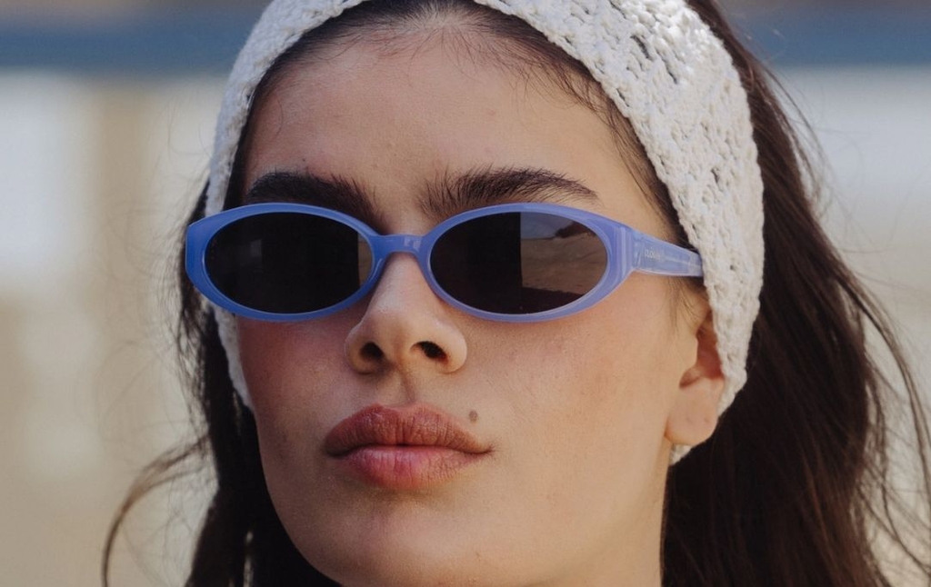 Model wearing 002 Icy Blue Sunglasses with Grey Lenses front profile