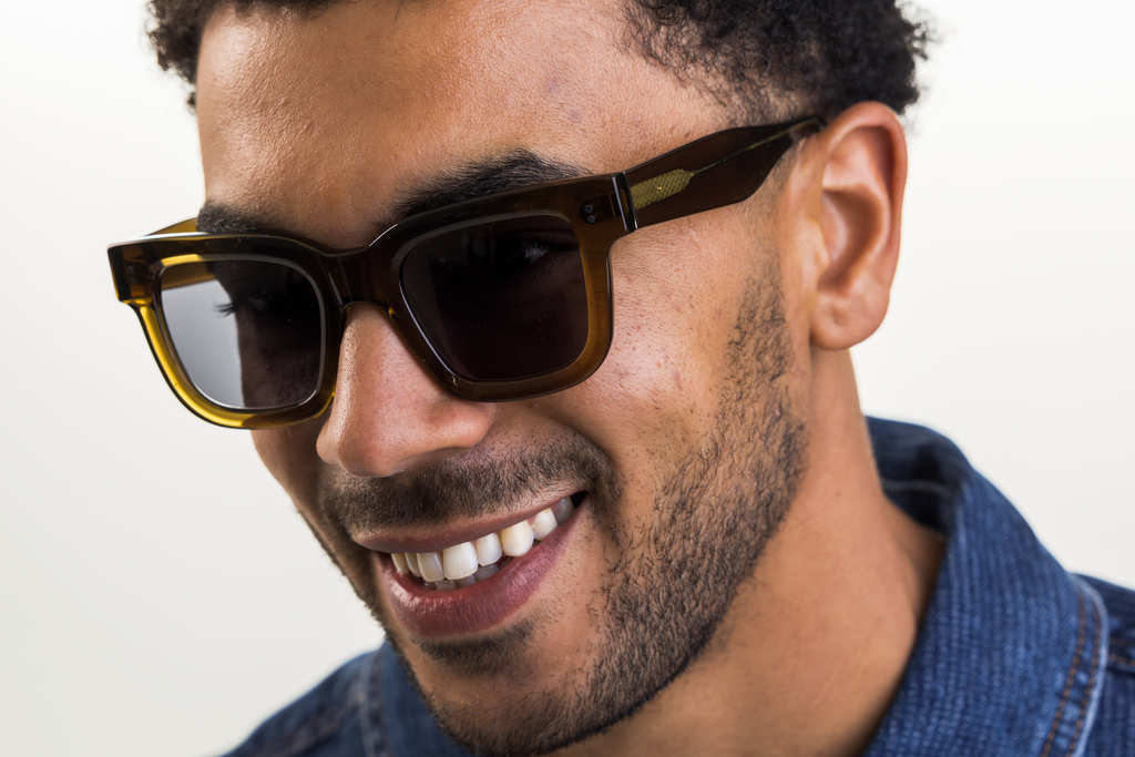 Male model wearing Husk Crystal sunglasses with grey lenses front profile