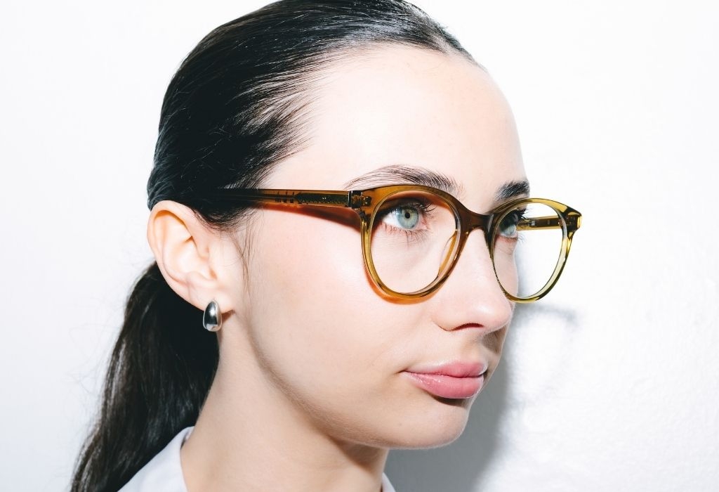 Female model wearing Crawford Husk Crystal Glasses side profile