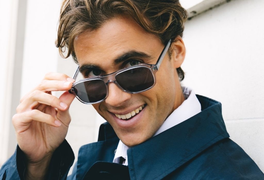 Male model wearing Lachlan Light Grey Crystal Sunglasses smiling