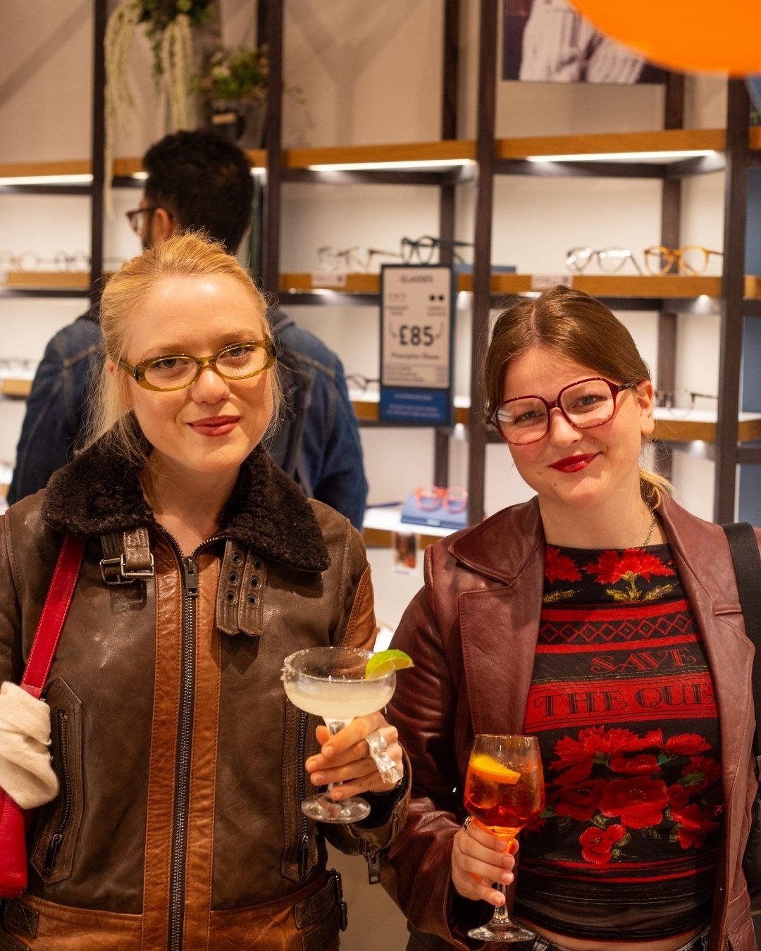 Two young female cx's wearing IOLLA glasses in showroom