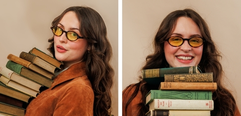 Black oval sunglasses with dark lenses and slim acetate frame, modern UK eyewear.