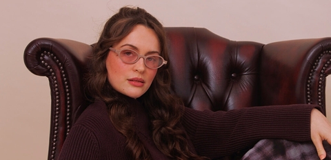 Translucent mocha oval sunglasses with soft blush tint lenses and lightweight acetate frame.