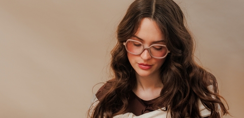 Model wearing translucent mocha brown round prescription glasses with acetate frame, UK eyewear.