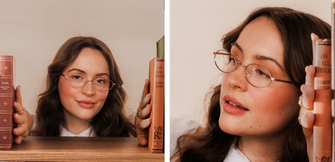 Model wearing gold metal oval glasses with slim wire frame and lightweight design.