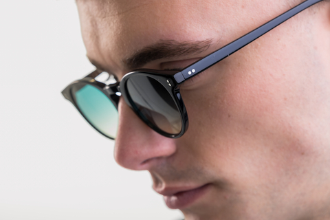 male model showcasing Bell. Sunglasses in Black with Lagoon Haze Gradient