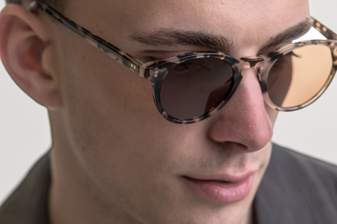 male model wearing Bell sunglasses in Vanilla Tortoise with Brown Lenses