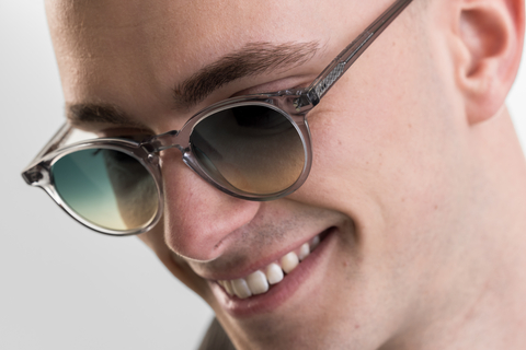 male model wearing Bell sunglasses in Light Grey Crystal with Lagoon Haze Gradient