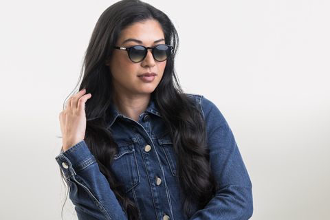 female model showcasing Bell. Sunglasses in Black with Lagoon Haze Gradient