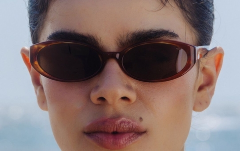 Model wearing 002 Cinnamon Swirl Sunglasses with Brown Lenses front profile