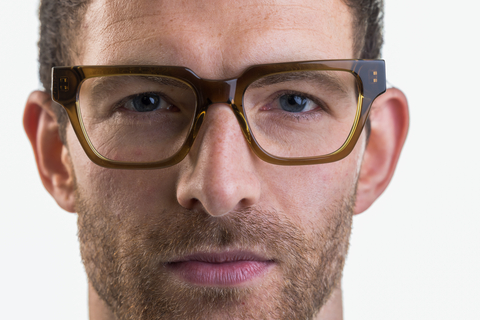 Male model wearing Macrae glasses in husk crystal front profile view